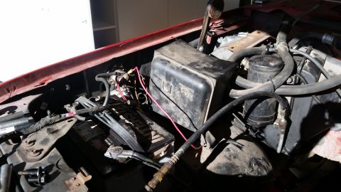1985 Ford Bronco - Close-up view of a vehicle's engine bay, showing various components and wiring.