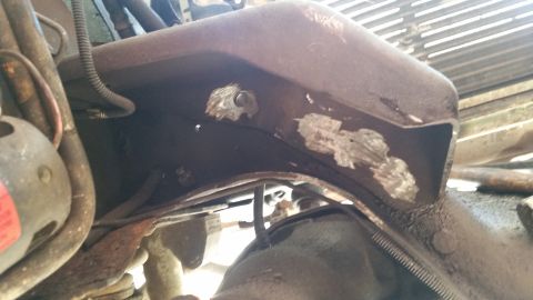 1985 Ford Bronco - This photo shows a close-up view of a vehicle's rusty frame and some engine components, with visible signs of repair.