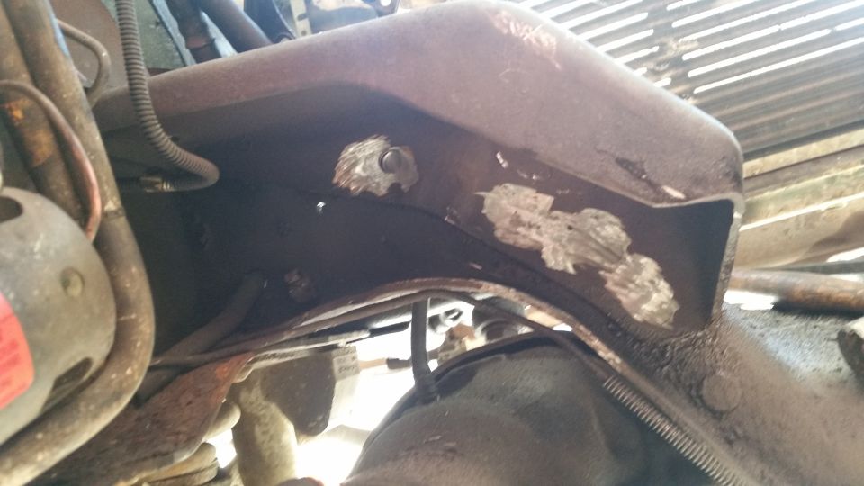 close-up of rusty vehicle frame with some engine parts visible