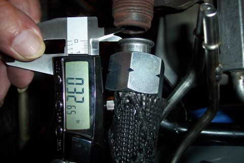 1995 Ford Bronco - A digital caliper is used to measure a component, showing a reading of 0.3265 inches.
