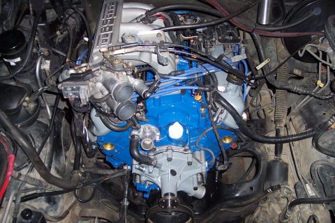 1995 Ford Bronco - Close-up view of an engine compartment, showing various mechanical components and wiring.