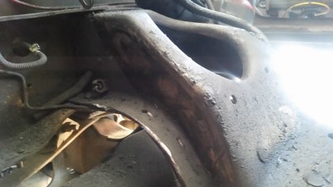1985 Ford Bronco - Close-up of a rusted metal frame component, likely from a vehicle's undercarriage.