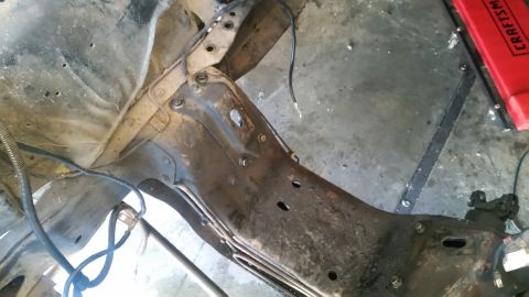 1985 Ford Bronco - This image shows the undercarriage and engine bay of a vehicle, focusing on the frame and associated components.