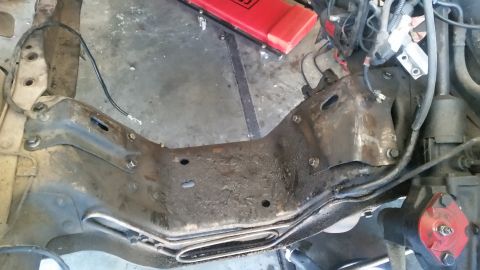 1985 Ford Bronco - Close-up of an engine mount bracket, likely from a Ford Bronco, with a Supermotors.net watermark visible.