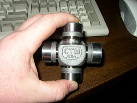 1995 Ford Bronco - A CTM USA universal joint is held in a hand, with a computer keyboard and mouse visible in the background.