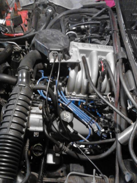 1995 Ford Bronco - Close-up view of an engine bay, showing various components and wiring.