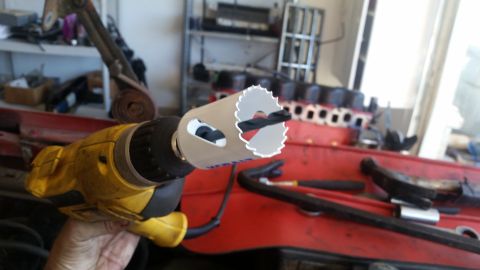1985 Ford Bronco - Drill with hole saw attachment, ready for use on an engine block.