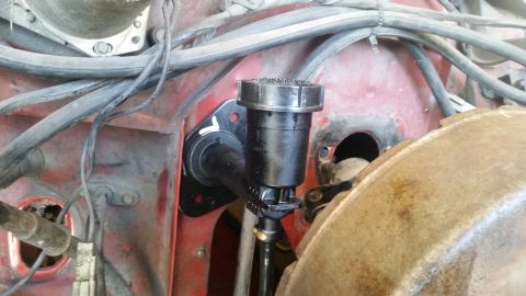 1985 Ford Bronco - Close-up view of the brake master cylinder and associated components on a vehicle's firewall.