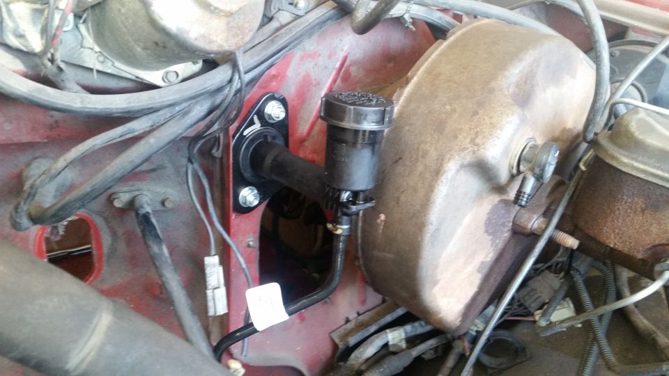 Clutch master cylinder and brake booster assembly in red engine bay