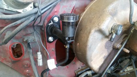 1985 Ford Bronco - Close-up of brake master cylinder and booster assembly, likely part of a vehicle's engine bay.