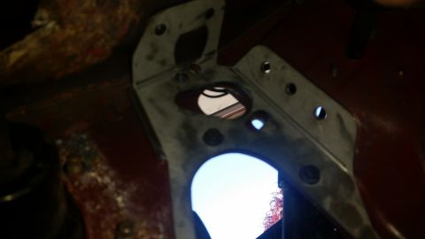 1985 Ford Bronco - This photo shows a metal bracket with multiple bolt holes, possibly from a vehicle's engine bay or undercarriage.