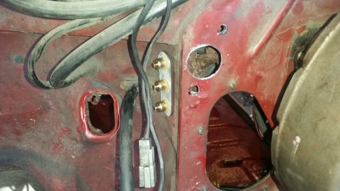 1985 Ford Bronco - Close-up view of a vehicle's firewall, showing signs of rust and modifications.