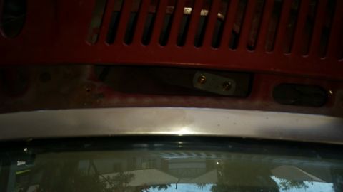 1985 Ford Bronco - Detail of a car's hood latch mechanism, likely from a Ford Bronco.