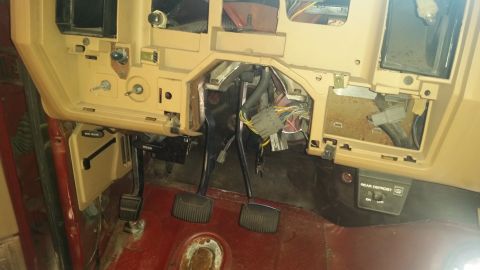 1985 Ford Bronco - The dashboard and wiring are exposed, showing the pedals and various electrical connections.