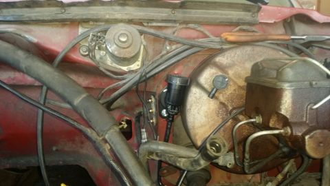 1985 Ford Bronco - Close-up view of engine bay components, including the brake master cylinder and vacuum booster.
