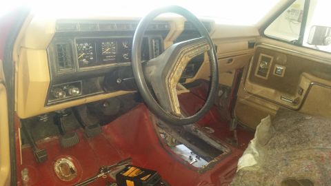 1985 Ford Bronco - Interior view of a 1985 Ford Bronco, showing the dashboard, steering wheel, and floor.