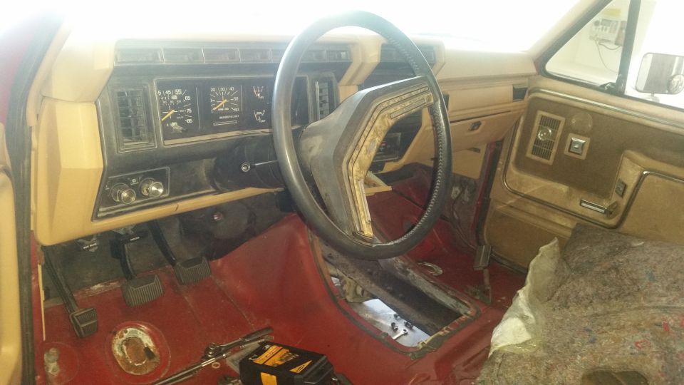 1985 Ford Bronco interior with red carpet and tan dashboard