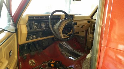 1985 Ford Bronco - Interior view of a truck, focusing on the dashboard, steering wheel, and floor area.