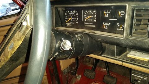 1985 Ford Bronco - Close-up of the driver's side interior, focusing on the instrument cluster and steering column.