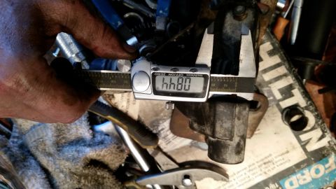 1985 Ford Bronco - Measuring a part with a digital caliper. The reading is 0.844 inches.