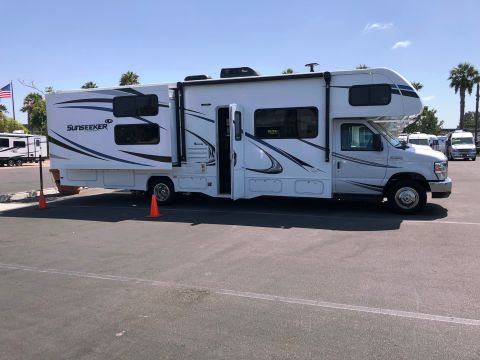 1992 Jeep Wrangler - This is a Sunseeker RV motorhome with its door open, parked outdoors.
