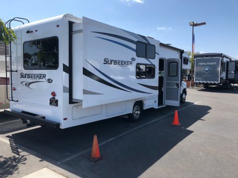 1992 Jeep Wrangler - This RV has its slide-out extended, revealing the 'Sunseeker LE' branding on the rear exterior.