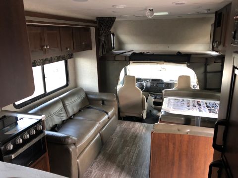 1992 Jeep Wrangler - Interior view of an RV showing the living area, kitchen, and driver's cockpit.