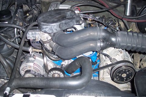 1995 Ford Bronco - Close-up view of an engine bay, showing intricate mechanical details and plumbing.