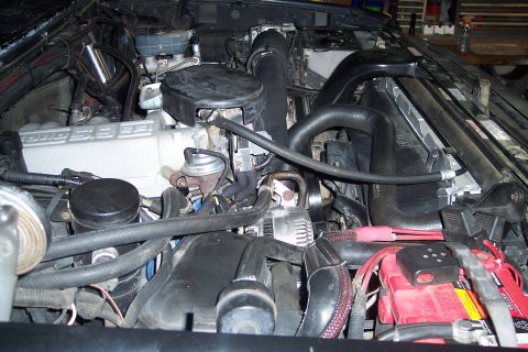 1995 Ford Bronco - Close-up view of an engine bay, showing the V8 5.8L engine and various components.