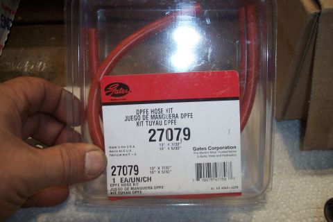 1995 Ford Bronco - A Gates DPFE hose kit is shown in its packaging, with a hand holding it.