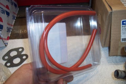 1995 Ford Bronco - A close-up shows an orange hose and a gasket, with a Ford oil filter box in the background.