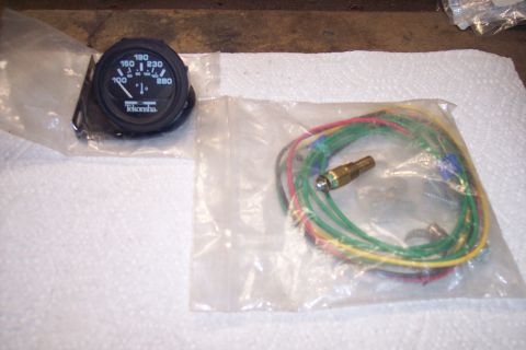 1995 Ford Bronco - A new temperature gauge and sending unit are shown, packaged separately.