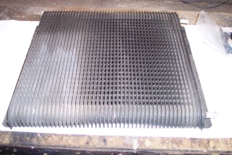 1995 Ford Bronco - A close-up view of a vehicle radiator or condenser, showing its intricate fin structure.