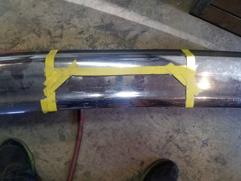 1995 Ford Bronco - Chrome bumper with yellow tape indicating a modification area, likely for a winch installation.