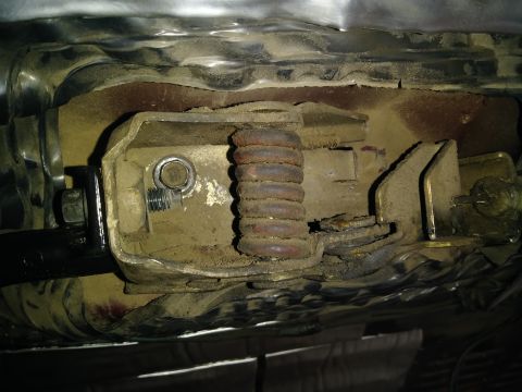 1996 Ford Bronco - Close-up of a vehicle's internal door handle mechanism, showing wear and dust accumulation of dirt.