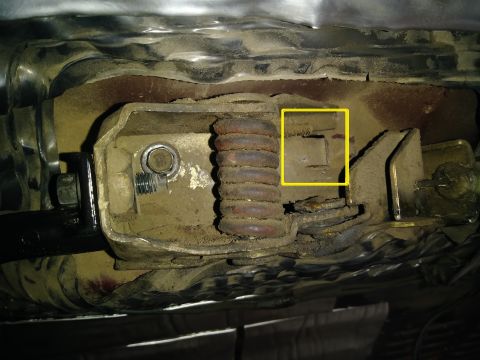1996 Ford Bronco - Detail of a vehicle's suspension system, showing a spring and metal components.
