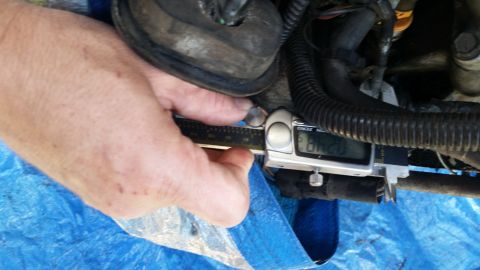 1985 Ford Bronco - Measuring an engine part with digital calipers. The reading shows 6.00.