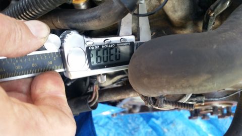 1985 Ford Bronco - Measuring engine component with a digital caliper. The reading is 0.309 inches.