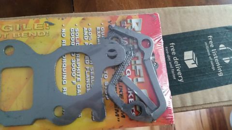 1985 Ford Bronco - Two exhaust gaskets are laid out on top of packaging that includes text about 'fragile', 'graphite', and '3000 F'. A portion of an Amazon p…