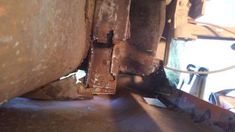 1996 Ford Bronco - This close-up photo shows heavily rusted metal framing and body panels, likely from the undercarriage of a vehicle. The damage suggests sig…