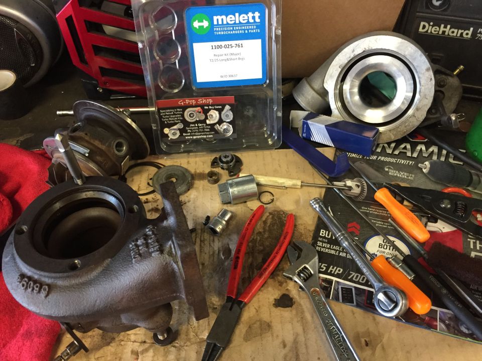 Turbocharger parts and tools on a workbench