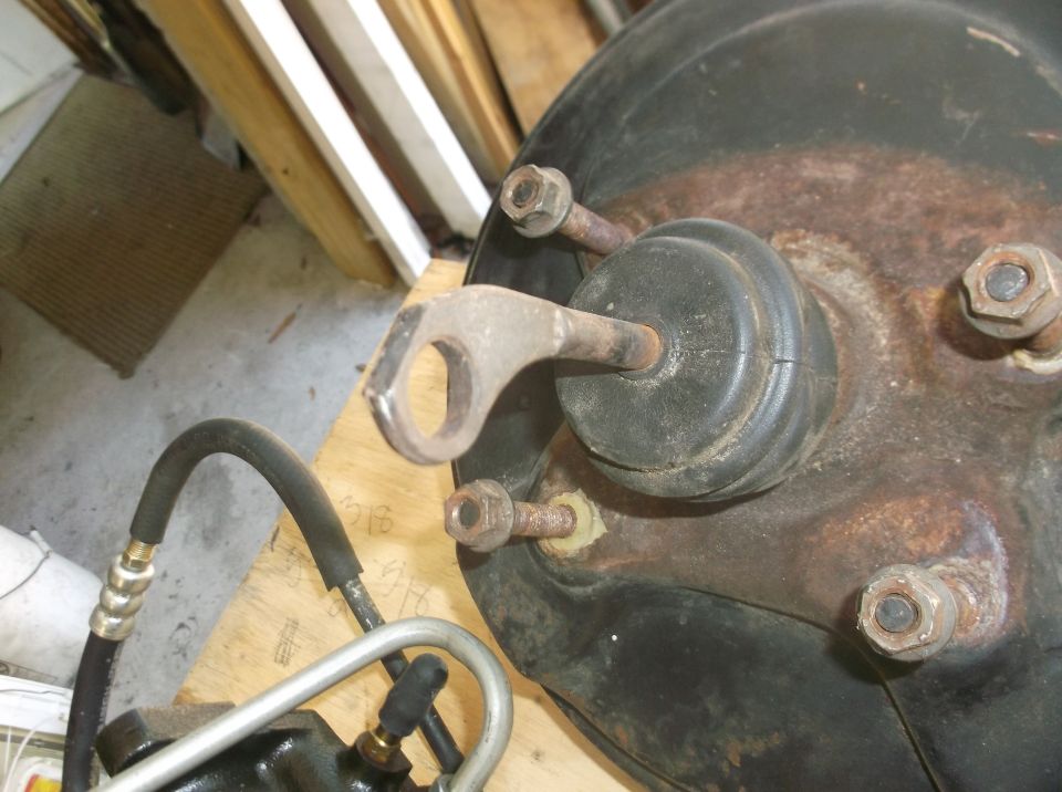 Brake booster assembly with metal bracket and rubber diaphragm