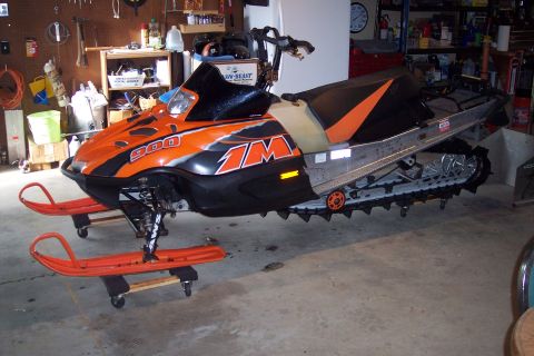 2004 Arctic Cat King Cat 900 - This snowmobile, identified as a 2004 Arctic Cat King Cat 900, is shown in a garage setting.