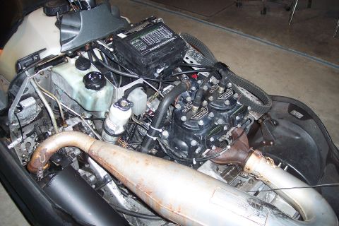 2004 Arctic Cat King Cat 900 - Close-up of a snowmobile engine, showing triple cylinders and exhaust system.