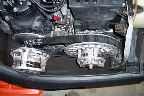 2004 Arctic Cat King Cat 900 - Close-up view of a snowmobile's engine and drivetrain components, including the drive belt and clutches.