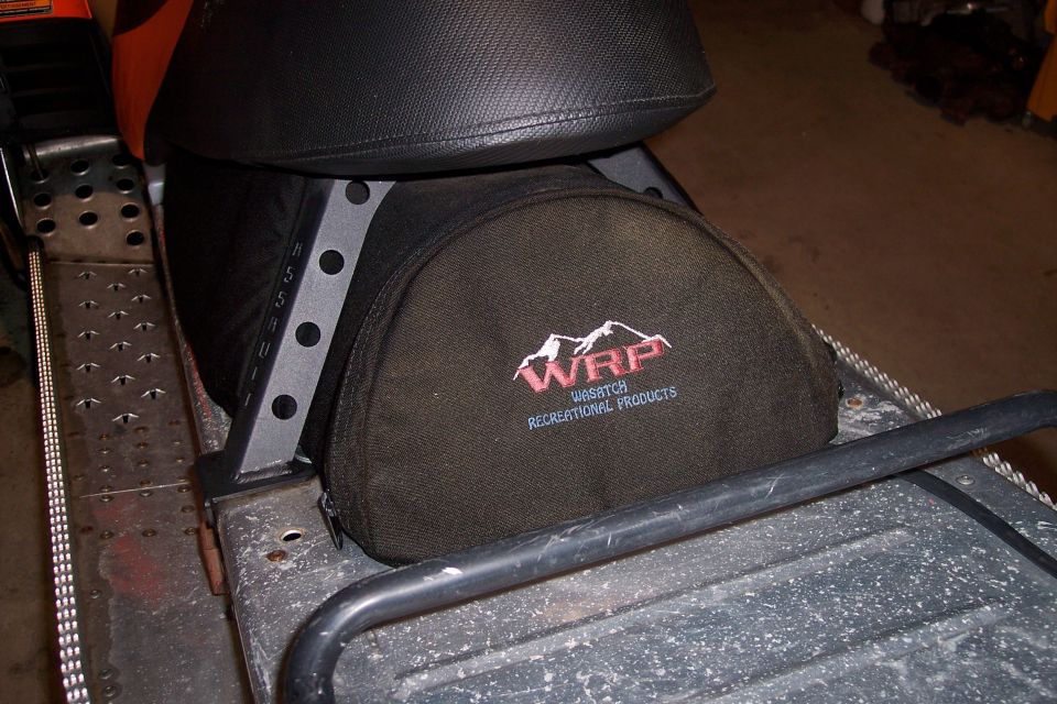 Snowmobile seat with a WRP Wasatch Recreational Products storage bag attached