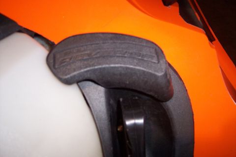 2004 Arctic Cat King Cat 900 - Close-up of a snowmobile's orange body panel and a black grip pad.
