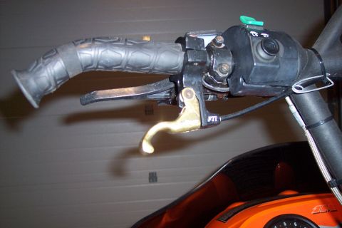 2004 Arctic Cat King Cat 900 - Close-up view of snowmobile handlebars, showing the throttle and brake lever assembly.