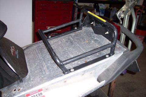 2004 Arctic Cat King Cat 900 - Rear rack and seat of a snowmobile, showing metal and black plastic components.