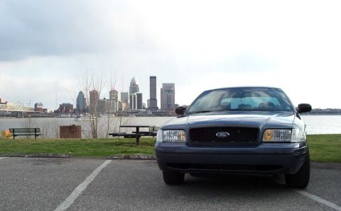 1998 Ford Crown Victoria - Front view of a 1998 Ford Crown Victoria parked near a waterfront with a city skyline.